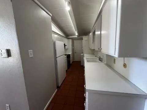 a kitchen with appliances cabinets and a sink