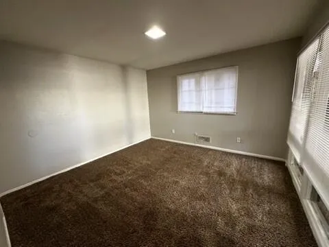 an empty room with large windows