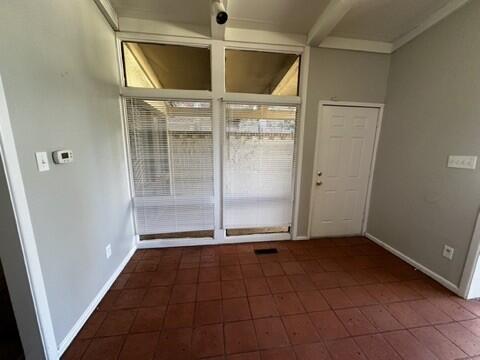 2003 32nd Street, Unit A Lubbock, TX 79411 - Photo 9 of 22 an empty room with wooden floor and windows