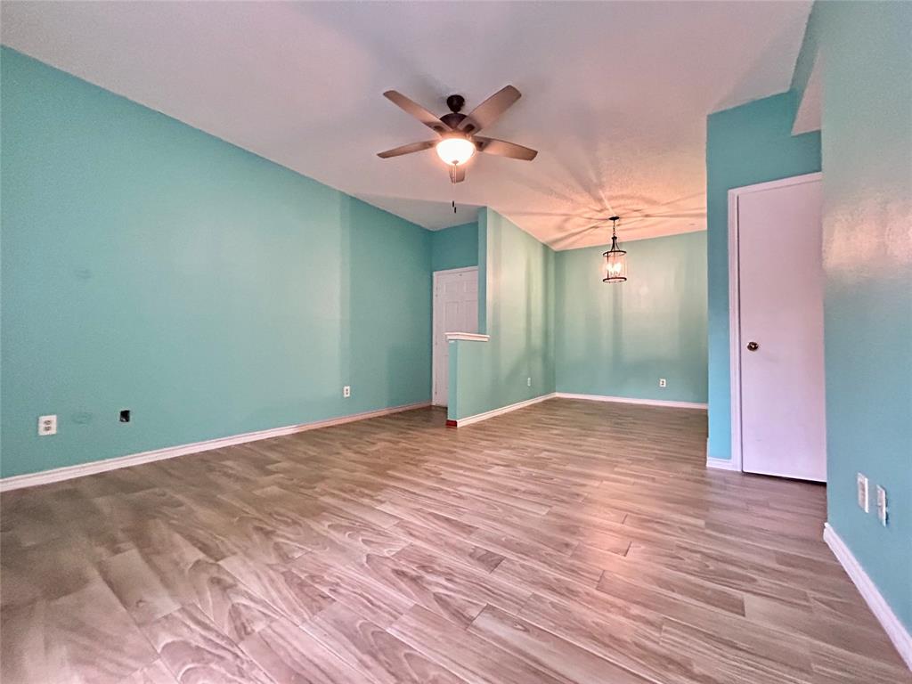 3609 West Northgate Drive, Unit 116 Irving, TX 75062 - Photo 2 of 8 a view of a livingroom with a ceiling fan and wooden floor