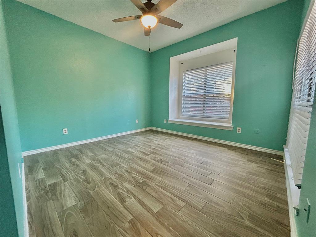 3609 West Northgate Drive, Unit 116 Irving, TX 75062 - Photo 5 of 8 an empty room with a window and a fan