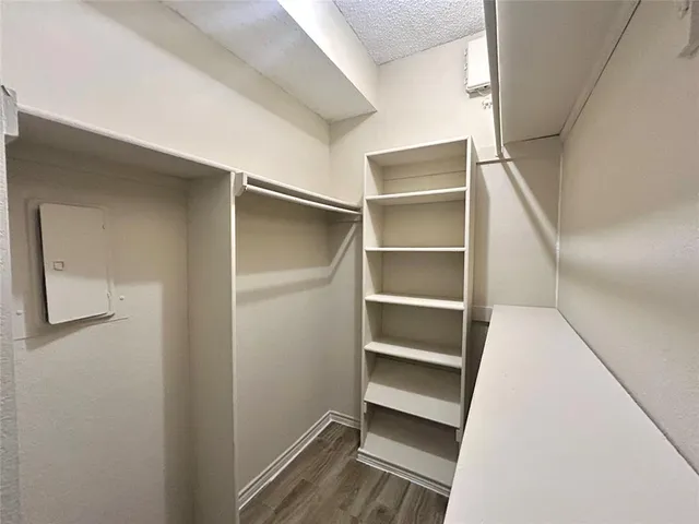 a view of walk in closet with empty racks