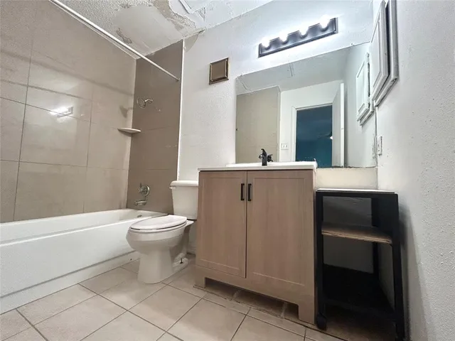 a bathroom with a toilet a sink and bathtub