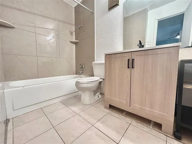 a bathroom with a toilet a sink and shower