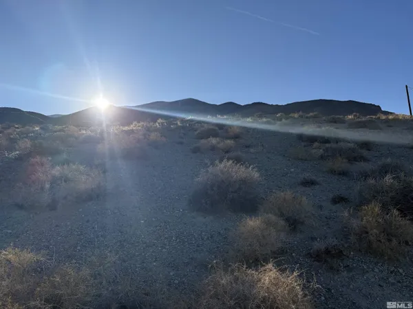 a sunset view with a lake