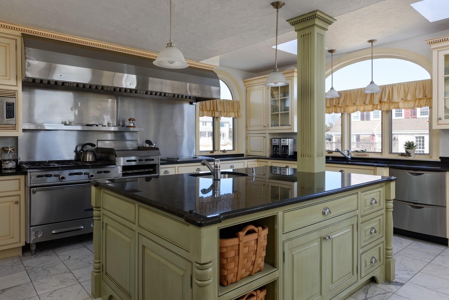 283 Long Beach Road Centerville, MA 02632 - Photo 20 of 30 a kitchen with stainless steel appliances granite countertop a stove a sink and a microwave