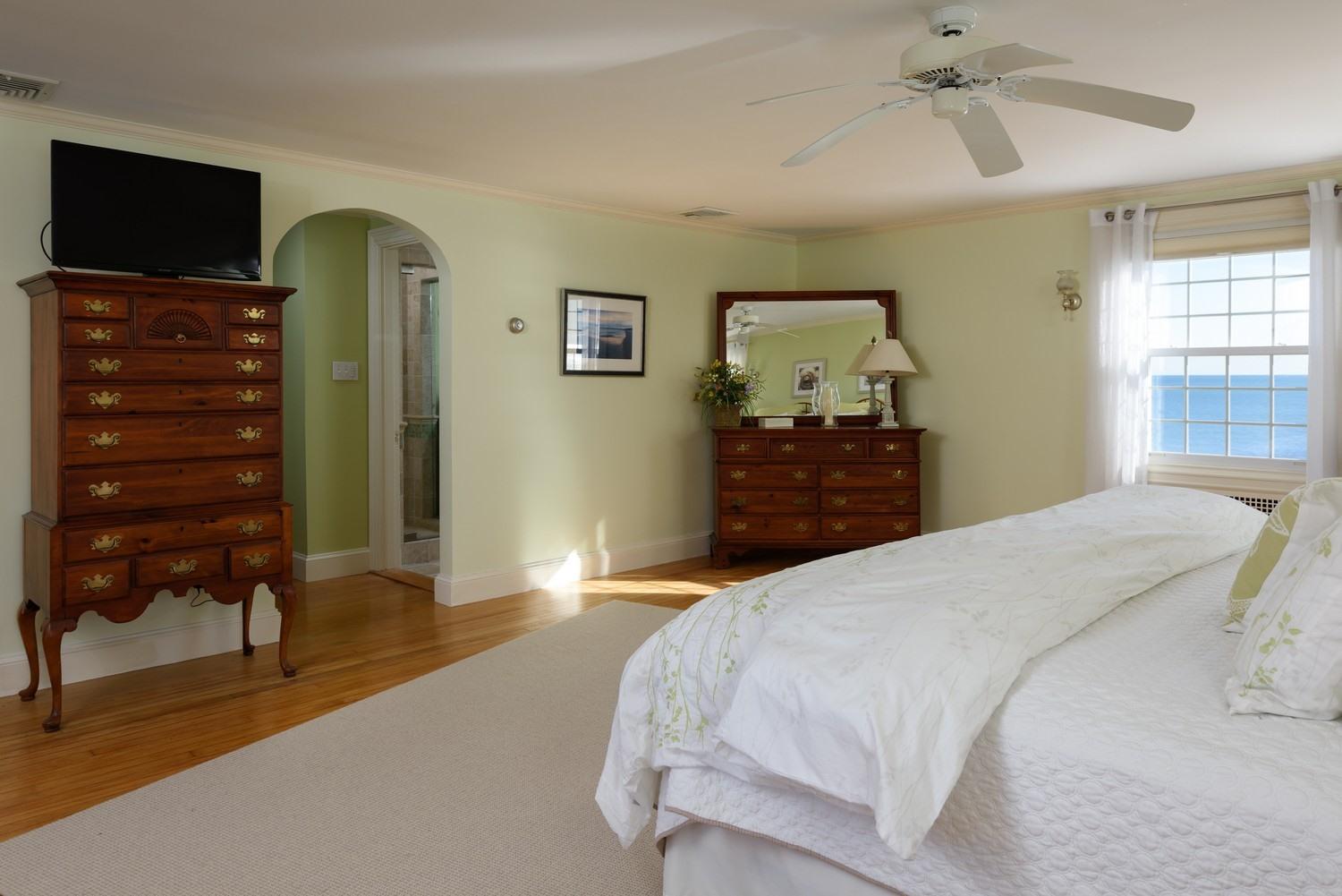 283 Long Beach Road Centerville, MA 02632 - Photo 26 of 30 a bedroom with a bed and wooden floor
