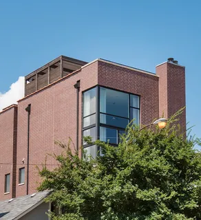 a front view of a house with plants