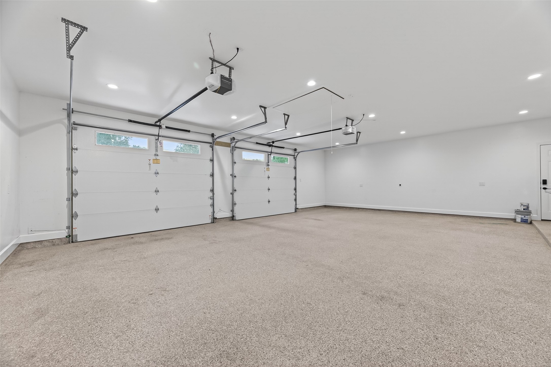 5638 Sanford Road Houston, TX 77096 - Photo 34 of 41 Oversized insulated garage doors with windows provide natural light and efficiency, complemented by a 220V outlet for an electric vehicle charger, while the attic space is designed to accommodate a future room and stair expansion.