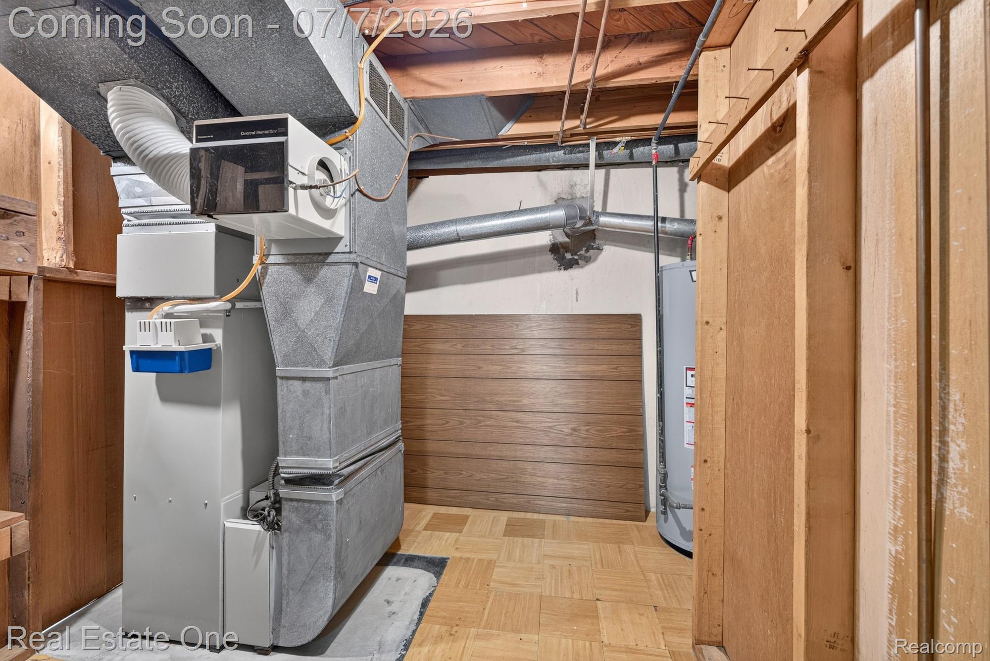 24749 Munson Street Taylor, MI 48180 - Photo 22 of 28 Utility area featuring a furnace, exposed ductwork, water heater, and wood-finish flooring