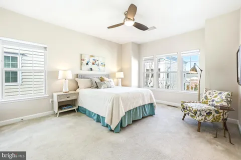 a spacious bedroom with a bed and a window