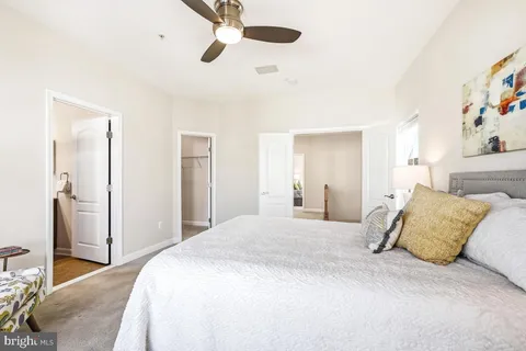 a bedroom with a large bed and a chandelier