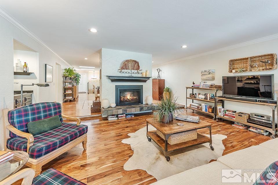 4945 West Lakeridge Terrace Reno, NV 89509 - Photo 13 of 25 a living room with furniture a flat screen tv and a fireplace