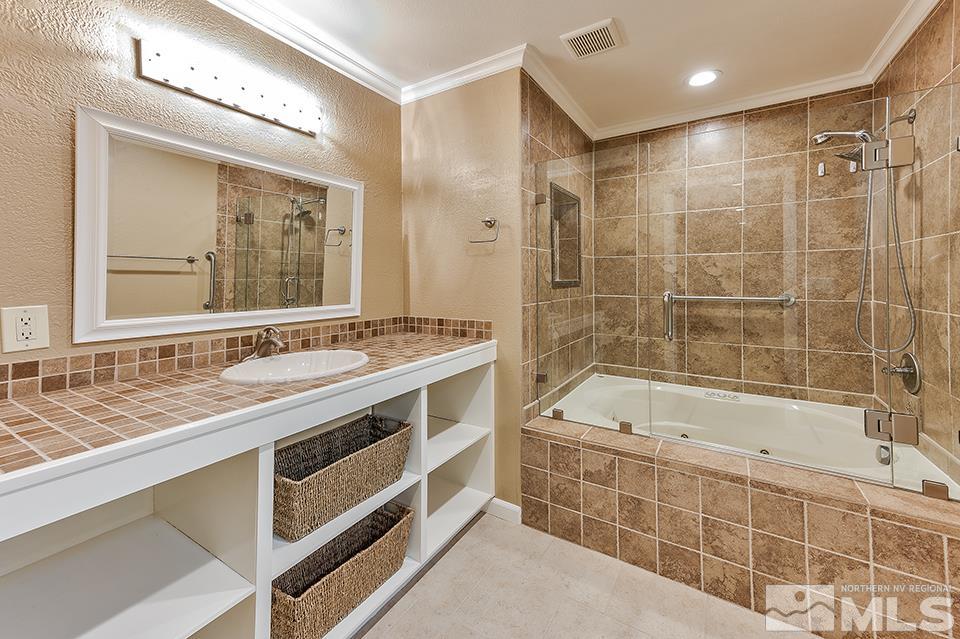 4945 West Lakeridge Terrace Reno, NV 89509 - Photo 16 of 25 a bathroom with a tub sink and mirror