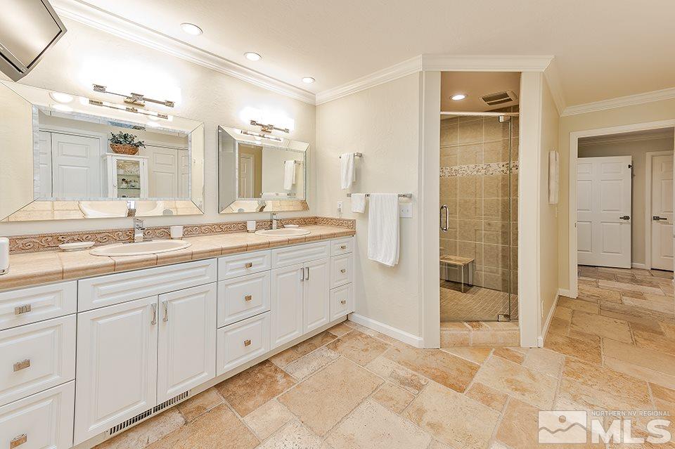 4945 West Lakeridge Terrace Reno, NV 89509 - Photo 19 of 25 a spacious bathroom with a granite countertop sink mirror and shower