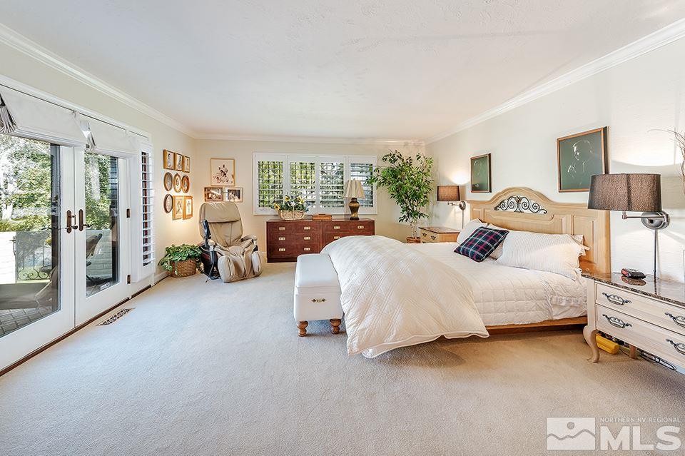 4945 West Lakeridge Terrace Reno, NV 89509 - Photo 20 of 25 a spacious bedroom with a bed couch and a large window