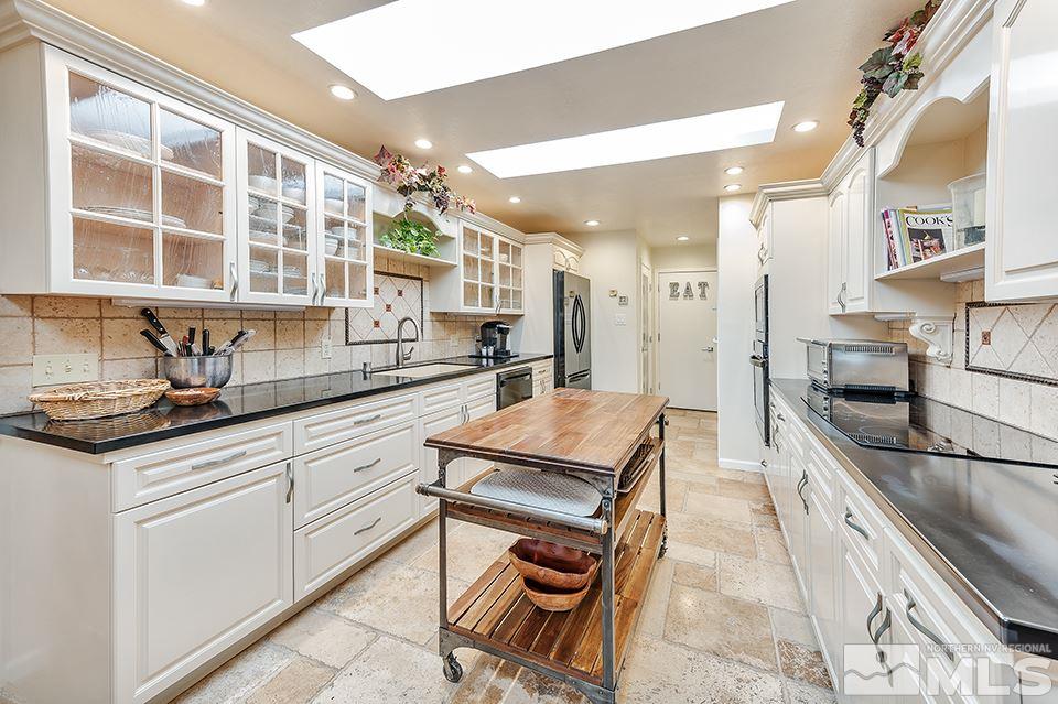 4945 West Lakeridge Terrace Reno, NV 89509 - Photo 8 of 25 a kitchen with stainless steel appliances granite countertop a stove and a sink