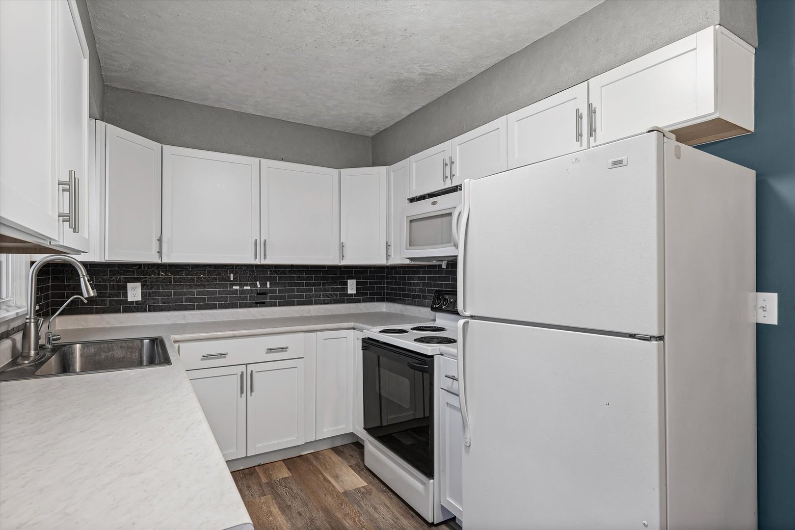 215 North 3rd Street Fisher, IL 61843 - Photo 13 of 32 a white refrigerator freezer sitting inside of a kitchen