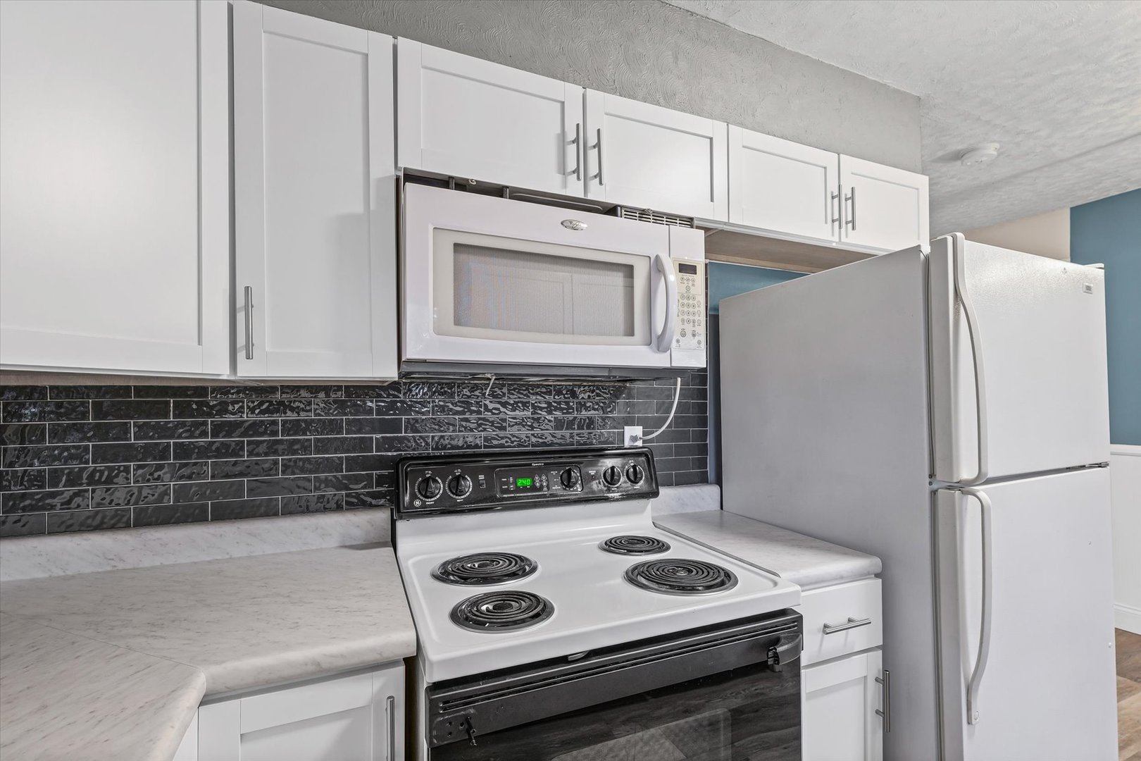 215 North 3rd Street Fisher, IL 61843 - Photo 15 of 32 a kitchen with a stove and a refrigerator