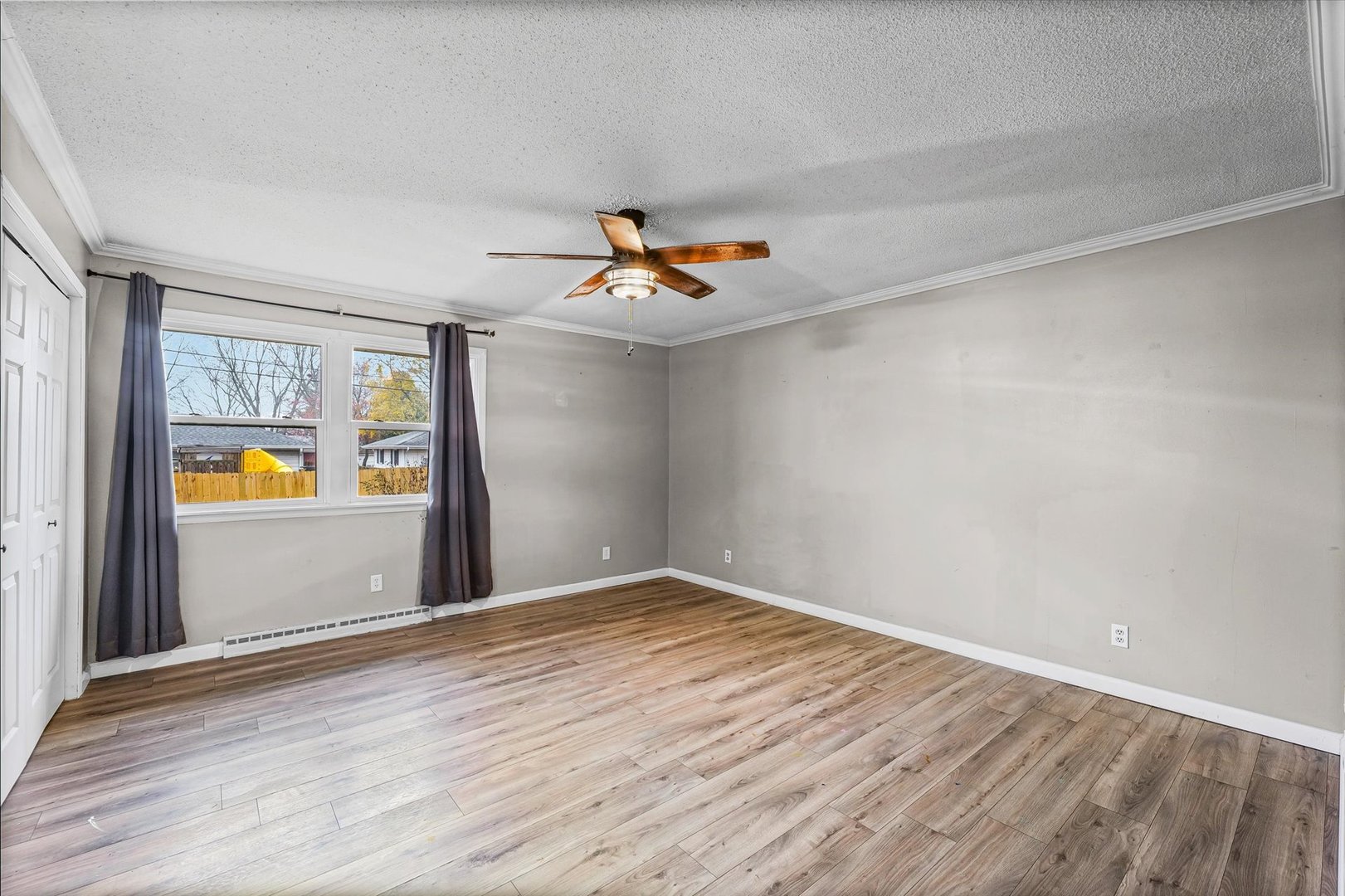 215 North 3rd Street Fisher, IL 61843 - Photo 18 of 32 an empty room with window and wooden floor