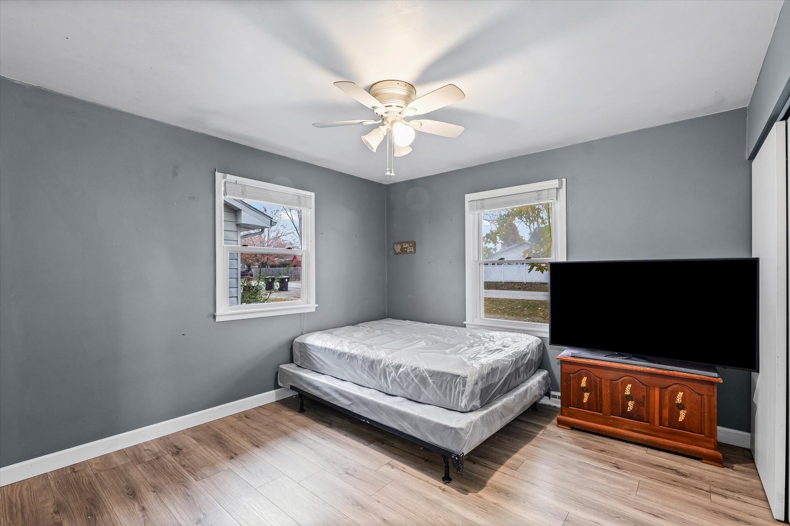 215 North 3rd Street Fisher, IL 61843 - Photo 24 of 32 a bedroom with a bed and a flat screen tv