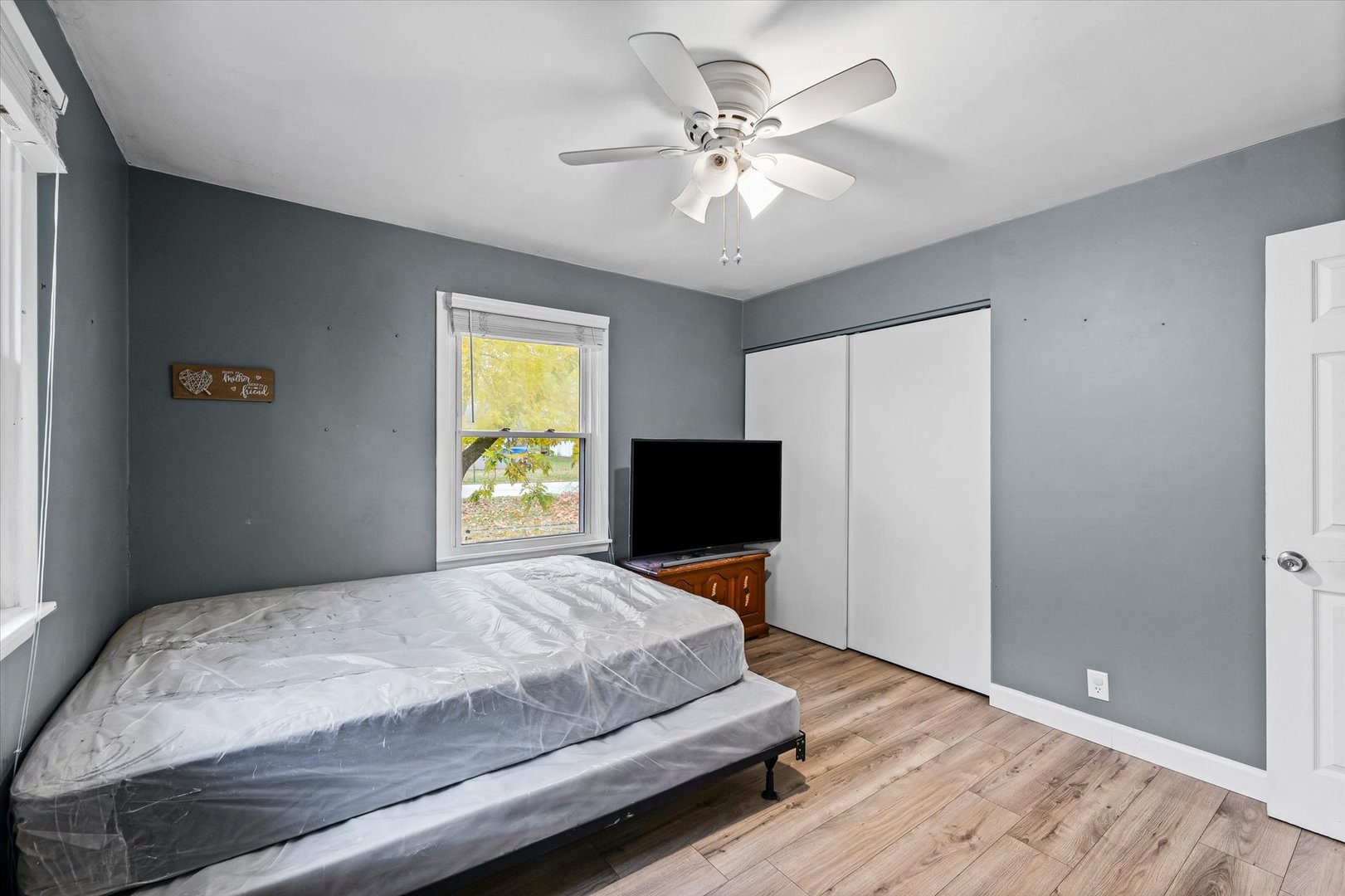 215 North 3rd Street Fisher, IL 61843 - Photo 25 of 32 a bedroom with a bed window and a flat screen tv