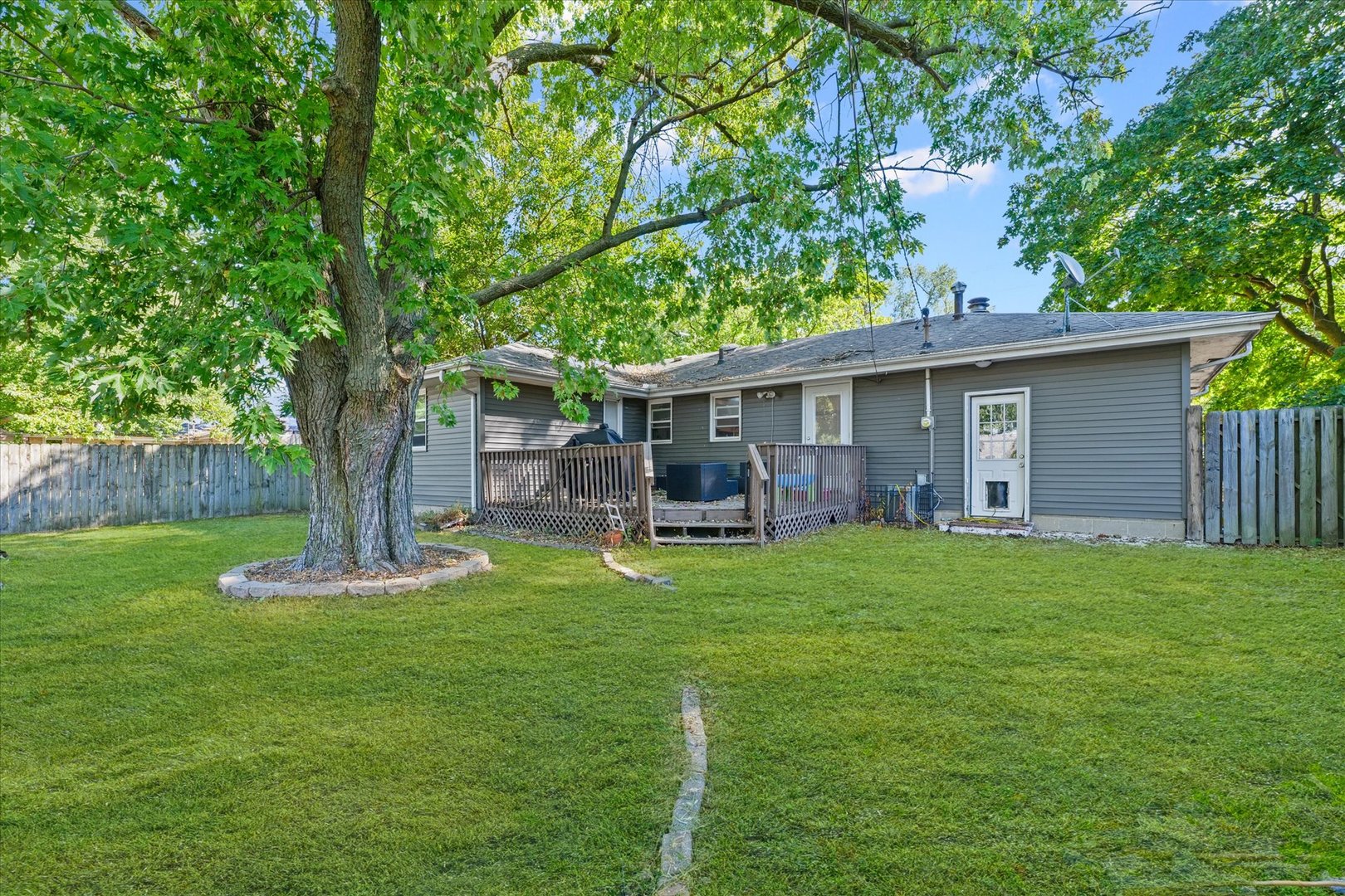 215 North 3rd Street Fisher, IL 61843 - Photo 29 of 32 a front view of house with a garden and trees