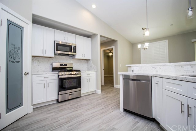 15648 Halinor Street Hesperia, CA 92345 - Photo 11 of 24 a kitchen with stainless steel appliances a stove a sink and a microwave