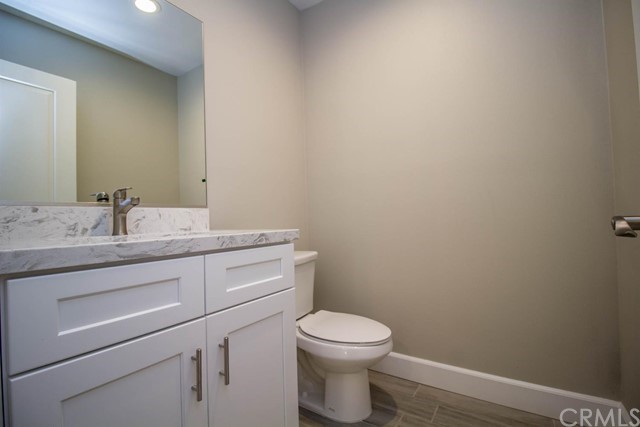 15648 Halinor Street Hesperia, CA 92345 - Photo 21 of 24 a bathroom with a granite countertop toilet and sink