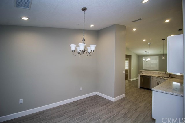 15648 Halinor Street Hesperia, CA 92345 - Photo 6 of 24 a view of a kitchen with a sink wooden floor and chandelier