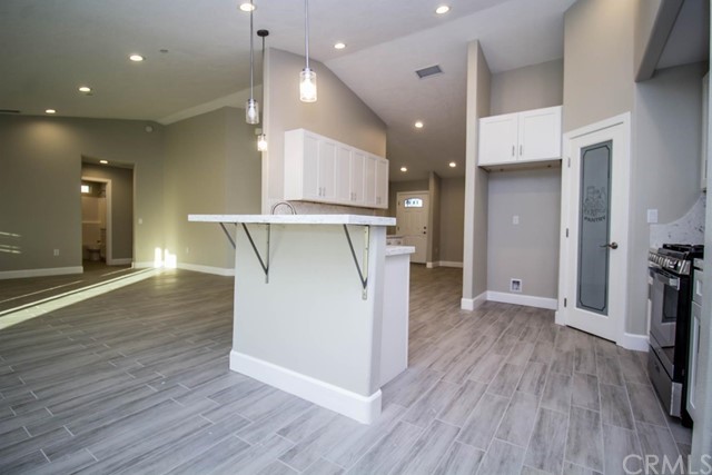 15648 Halinor Street Hesperia, CA 92345 - Photo 9 of 24 a view of a kitchen and a hallway with wooden floor