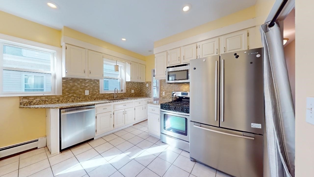 17 Gorham Road, Unit 2 Medford, MA 02155 - Photo 2 of 37 a kitchen with granite countertop stainless steel appliances a refrigerator sink and microwave