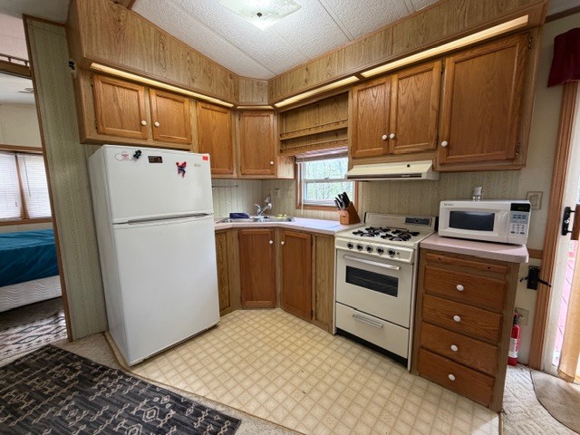 2795 East 28th Road Marseilles, IL 61341 - Photo 7 of 56 a kitchen with a refrigerator sink and cabinets