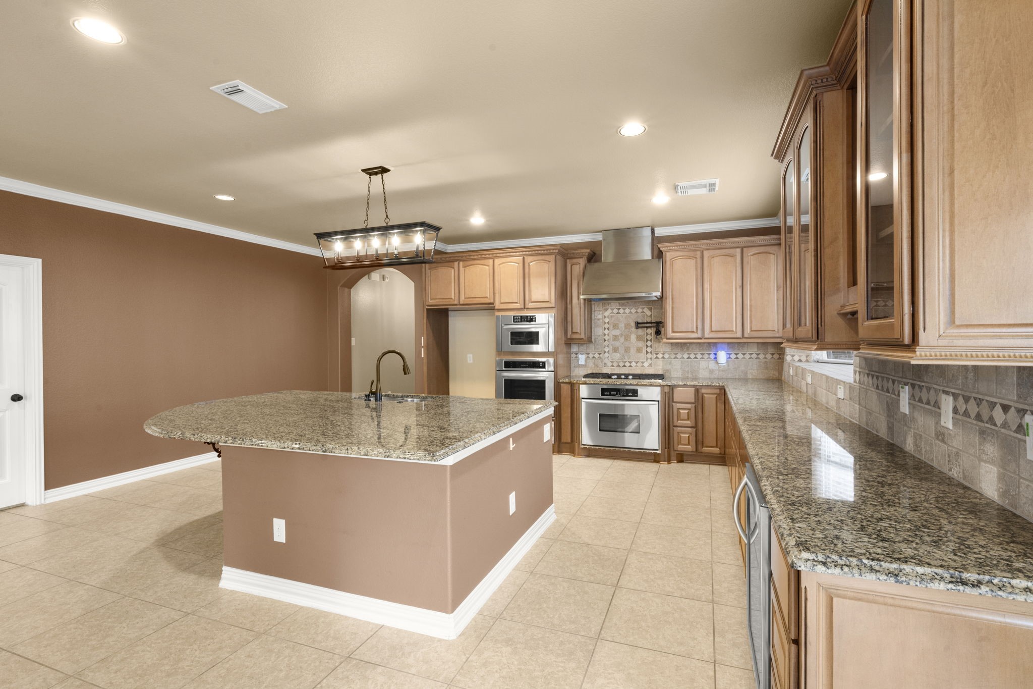 110 David Forest Lane Conroe, TX 77384 - Photo 15 of 35 a large kitchen with stainless steel appliances granite countertop a sink stove and refrigerator