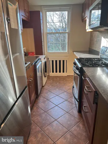 a kitchen with a sink a stove and a refrigerator
