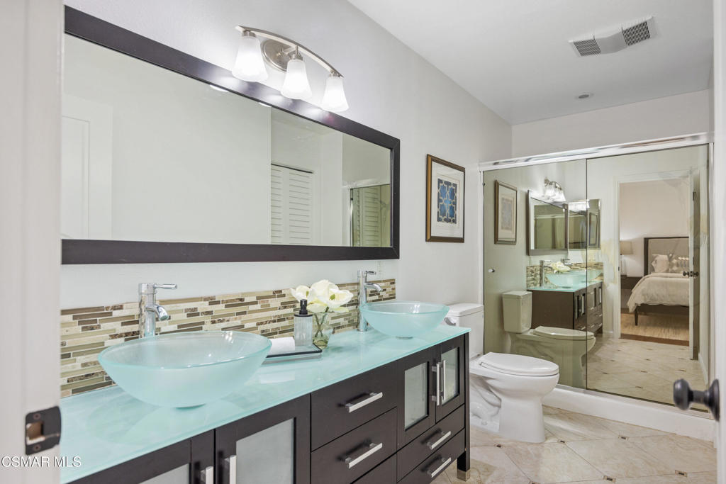 23637 Park Capri, Unit 36 Calabasas, CA 91302 - Photo 25 of 39 a bathroom with a granite countertop sink a mirror and a toilet