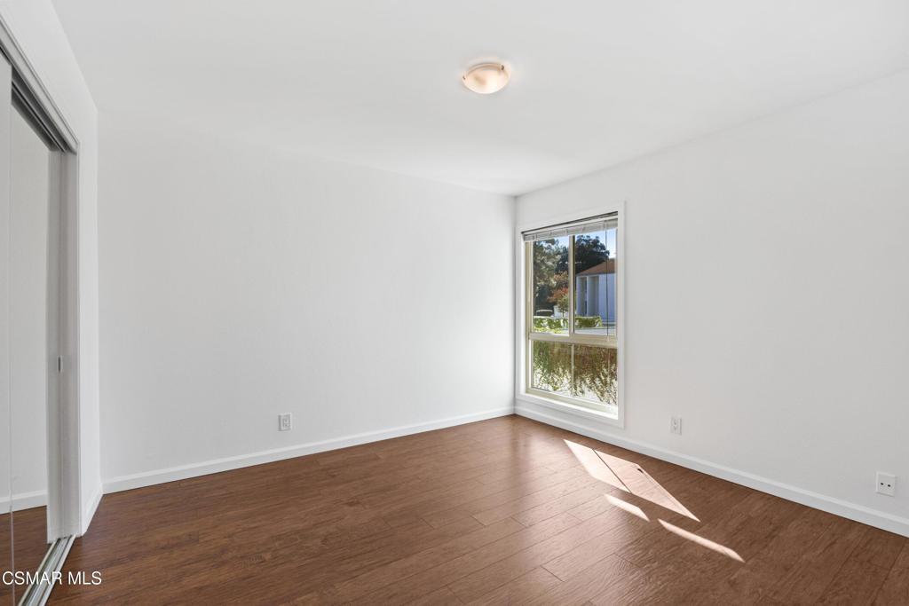 23637 Park Capri, Unit 36 Calabasas, CA 91302 - Photo 27 of 39 an empty room with wooden floor and windows