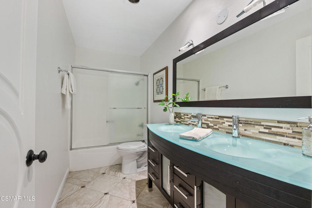 23637 Park Capri, Unit 36 Calabasas, CA 91302 - Photo 28 of 39 a bathroom with a sink a toilet a mirror and shower
