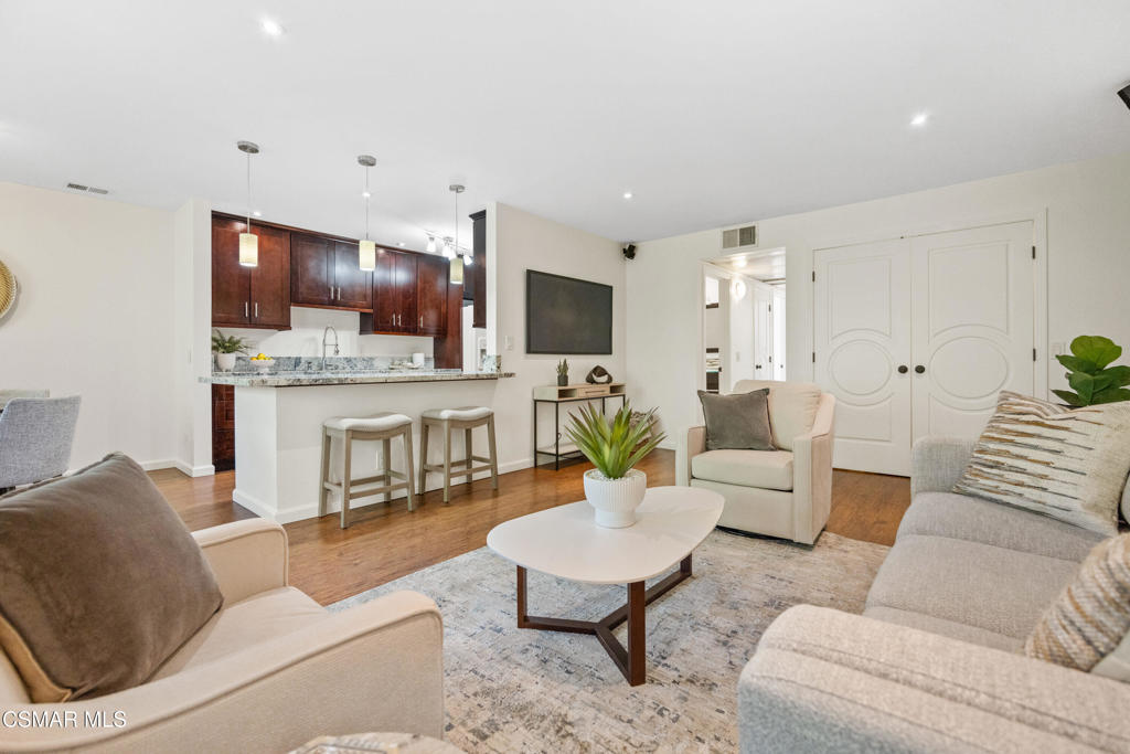 23637 Park Capri, Unit 36 Calabasas, CA 91302 - Photo 6 of 39 a living room with fireplace furniture and a flat screen tv