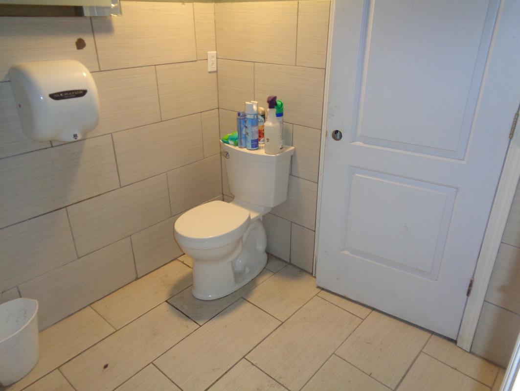 11629 South Green Street Chicago, IL 60628 - Photo 12 of 12 a bathroom with a toilet
