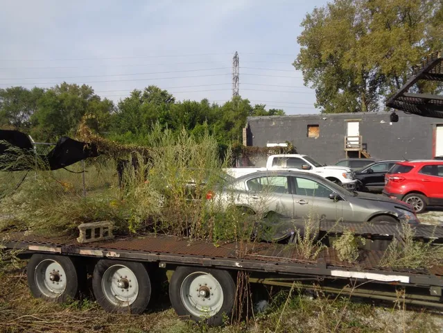 a view of a road with a car parked side of it