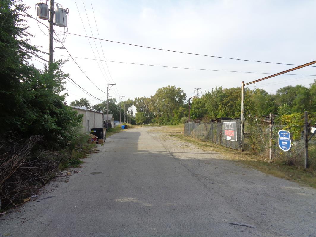 11629 South Green Street Chicago, IL 60628 - Photo 6 of 12 a view of a road with a car parked side of it