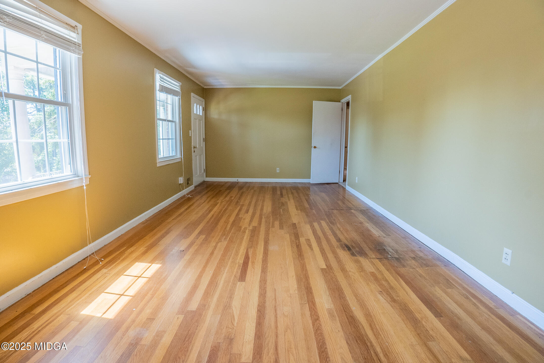 2939 General Lee Road Macon, GA 31204 - Photo 7 of 38 a view of an empty room with wooden floor and a window