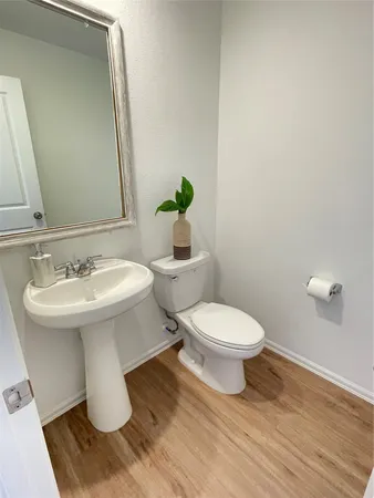 a bathroom with a sink toilet and a mirror