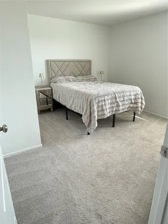 a bedroom with a bed and a table