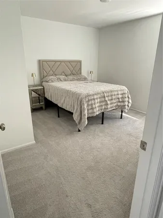 a bedroom with a bed and a desk