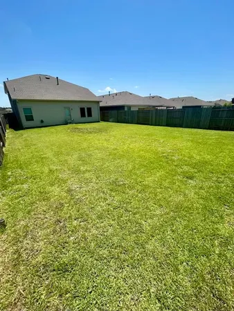 a view of a big house in a big yard with large trees