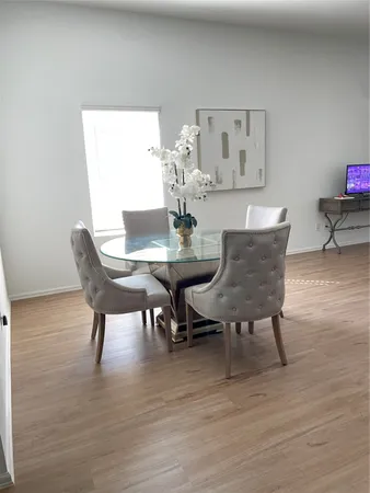 a view of a dining room with furniture and wooden floor