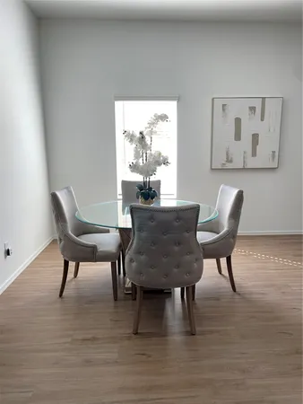 a dining room with furniture and wooden floor