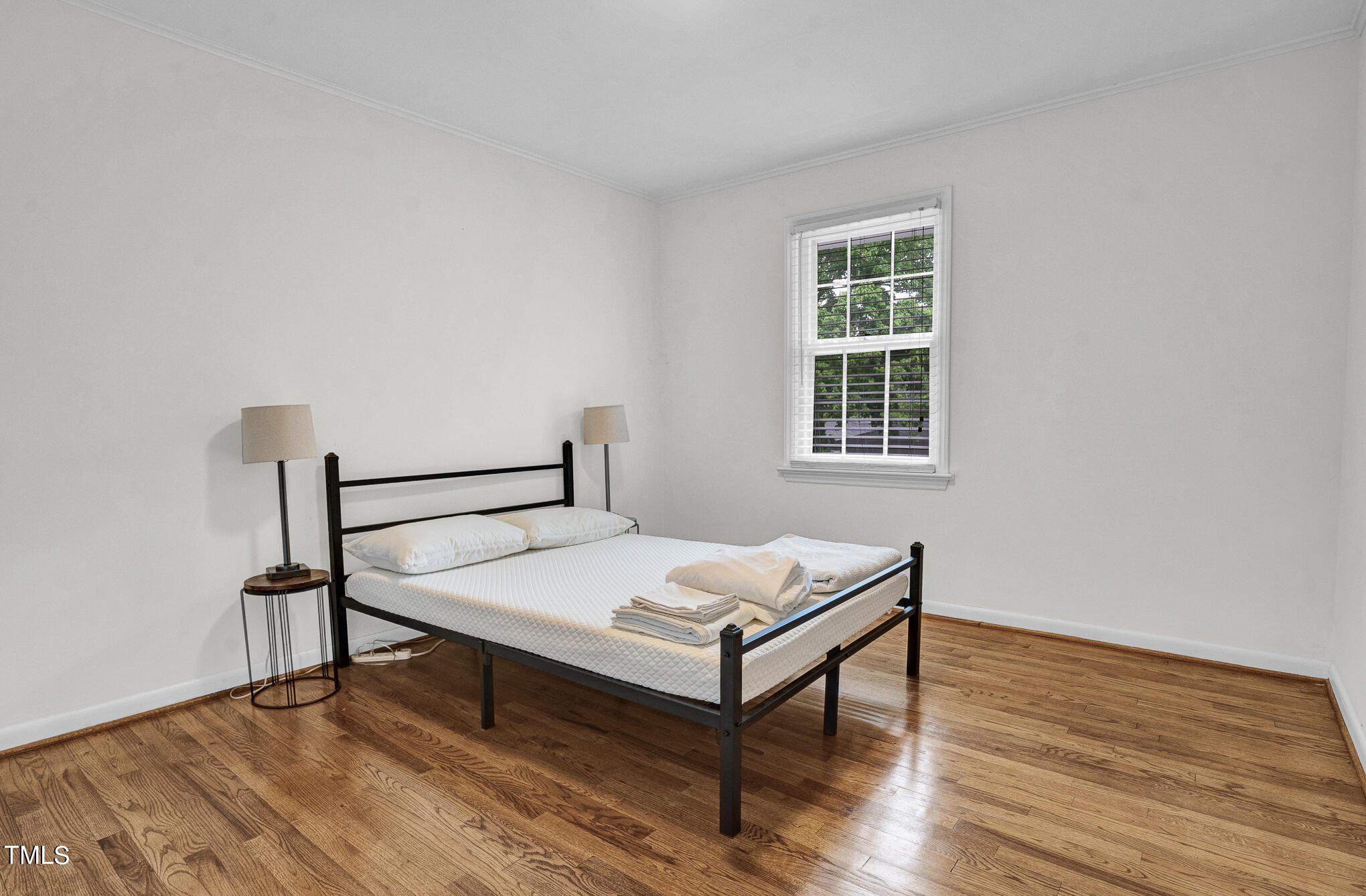 1941 Clark Avenue, Unit 101 Raleigh, NC 27605 - Photo 12 of 15 a bedroom with a bed and a window